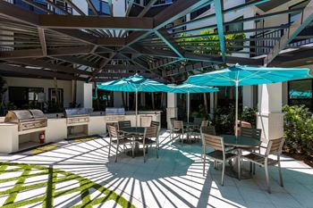 A patio with tables and chairs and umbrellas